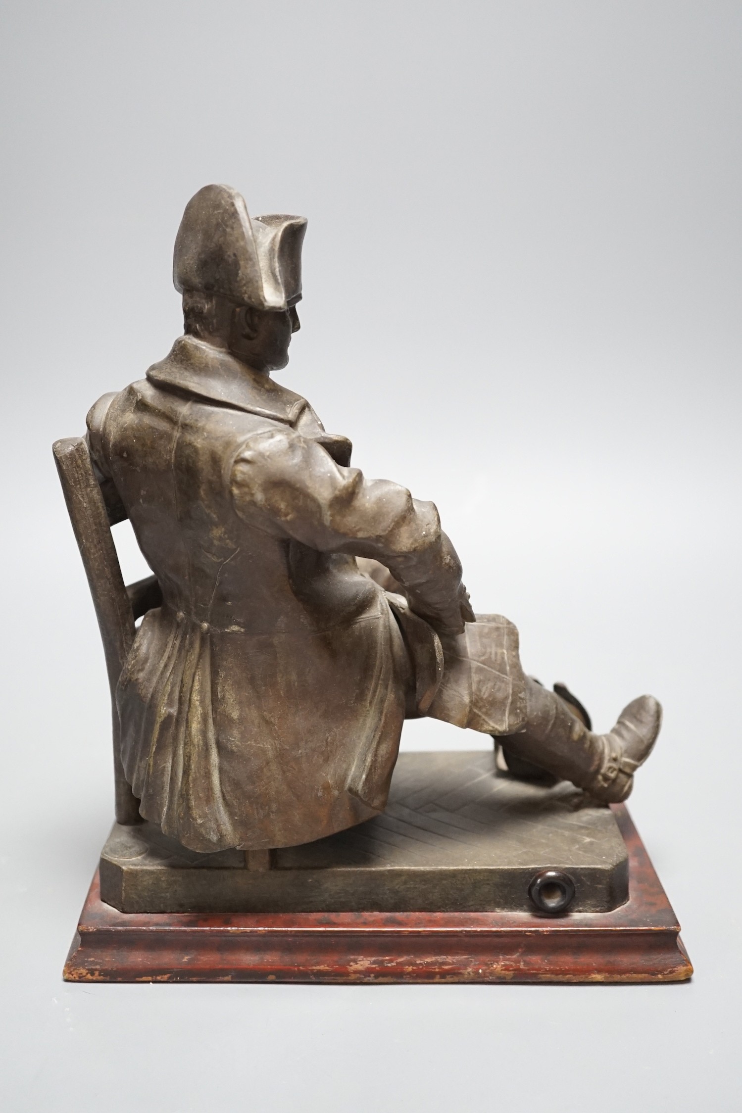 An early 20th century bronzed metal table lamp moulded as Napoleon seated, 26cm